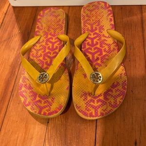 Tory Burch flip flop sandals in orange and pink pattern
